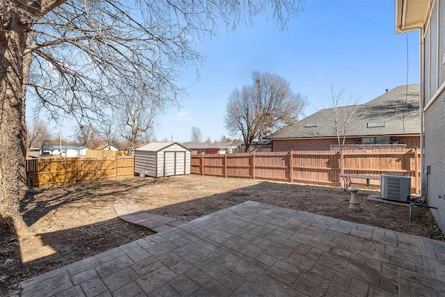 view of yard with a patio, a fenced backyard, cooling unit, an outdoor structure, and a shed