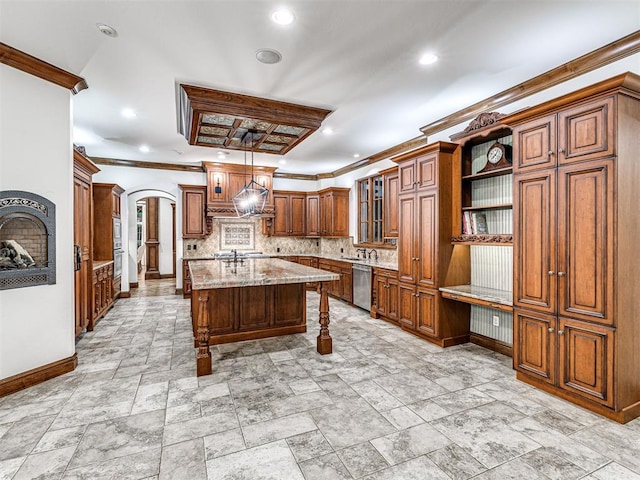 kitchen featuring arched walkways, light stone counters, a kitchen island with sink, dishwasher, and brown cabinetry