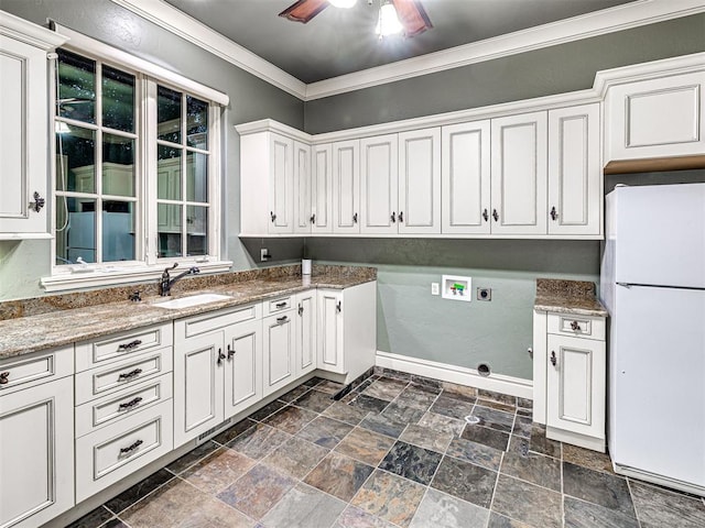 washroom featuring cabinet space, ornamental molding, hookup for a washing machine, electric dryer hookup, and a sink