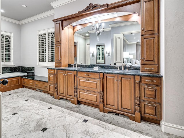 bathroom with a notable chandelier, double vanity, a textured wall, ornamental molding, and a sink