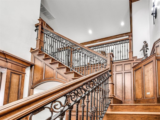 staircase featuring a high ceiling