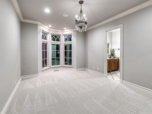 spare room with light colored carpet, crown molding, and baseboards