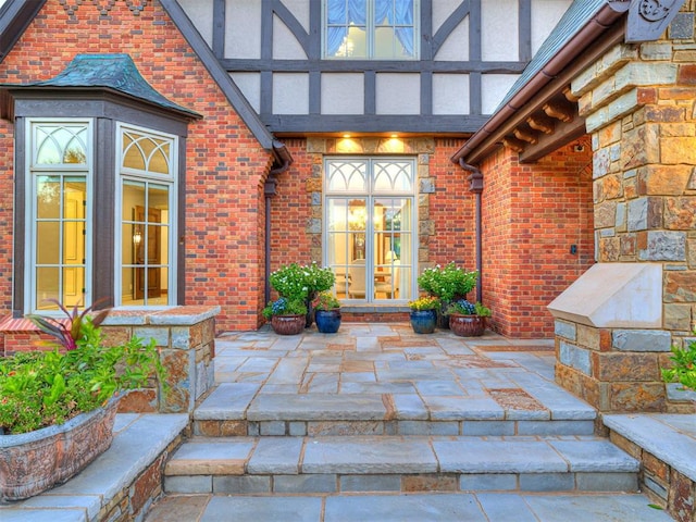 doorway to property with brick siding and stucco siding