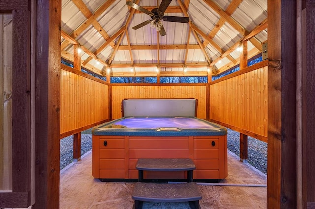 interior space featuring lofted ceiling and wood walls