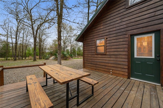 wooden terrace with outdoor dining area