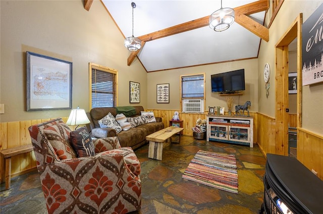 living room with wooden walls, beam ceiling, stone tile flooring, and wainscoting