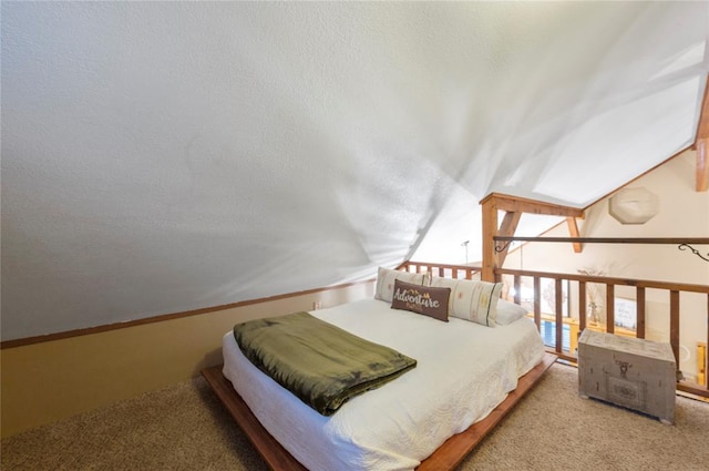 bedroom featuring vaulted ceiling and a textured ceiling