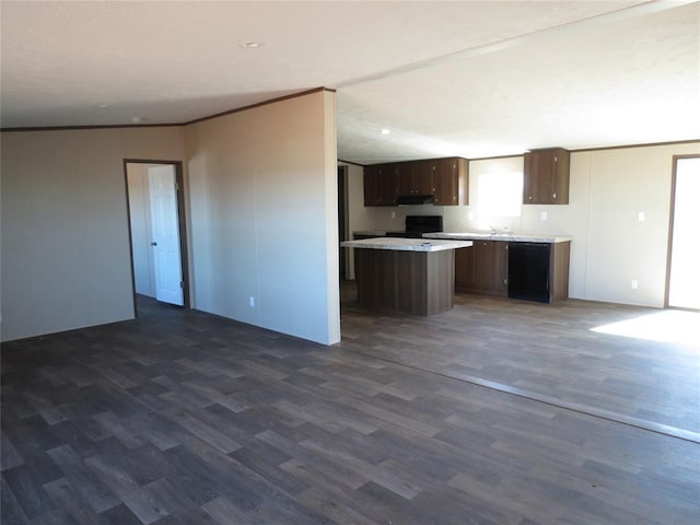 kitchen with dark wood finished floors, light countertops, open floor plan, a kitchen island, and black appliances