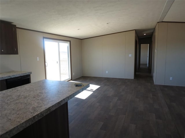 interior space with dark wood-style floors, light countertops, black dishwasher, and crown molding