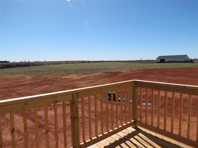 wooden deck featuring a rural view