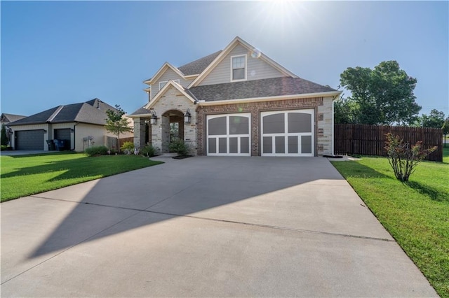 view of front facade with driveway, fence, a front lawn, and brick siding