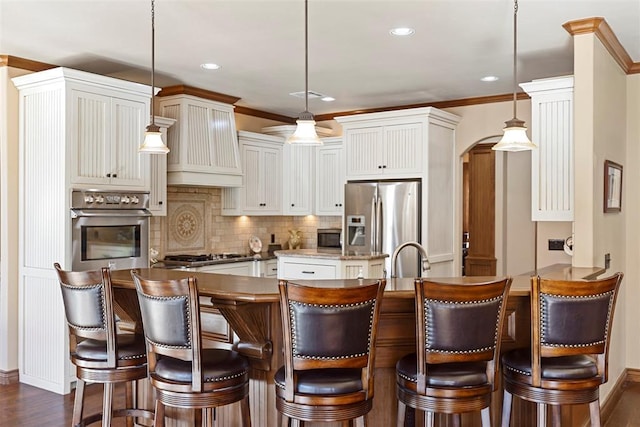 kitchen with arched walkways, custom exhaust hood, stainless steel appliances, decorative backsplash, and a peninsula