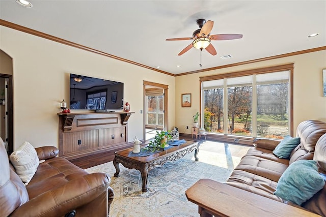 living room featuring crown molding, a ceiling fan, and wood finished floors