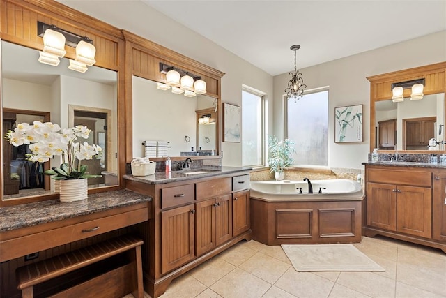 bathroom with a garden tub, two vanities, tile patterned flooring, and a sink