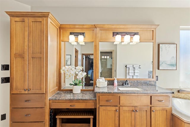 bathroom featuring vanity and a bath