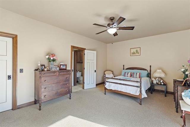 bedroom featuring a ceiling fan, light carpet, connected bathroom, and baseboards