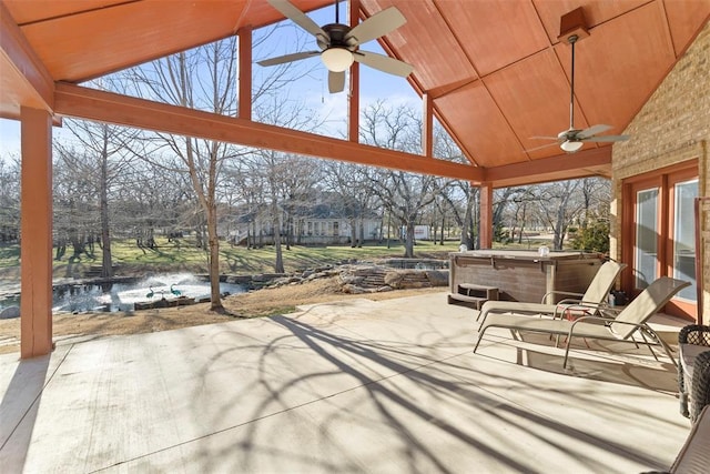 view of patio / terrace featuring a hot tub and a ceiling fan