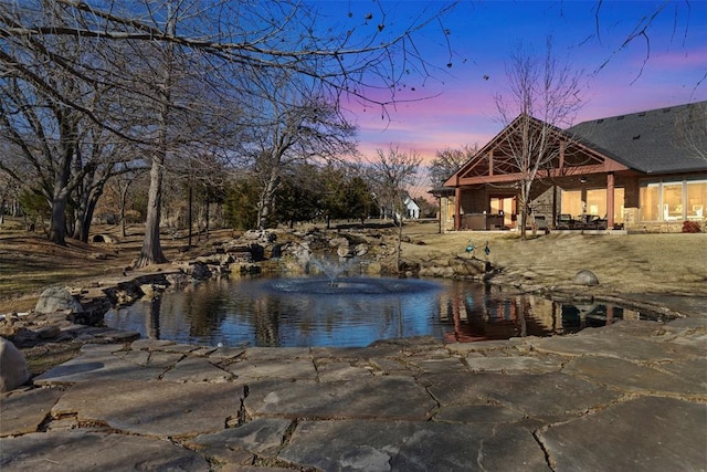 view of pool at dusk