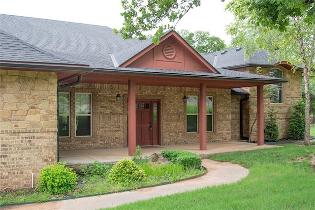 4600 Clipper Xing, Edmond, OK 73013 - view of exterior entry featuring roof with shingles, a porch, and brick siding