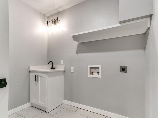 laundry area featuring hookup for a washing machine, hookup for an electric dryer, a sink, light tile patterned flooring, and laundry area