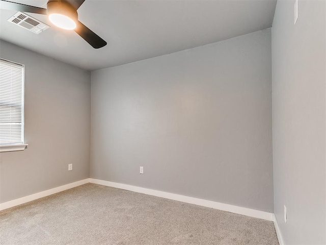 empty room featuring baseboards, carpet, visible vents, and a ceiling fan