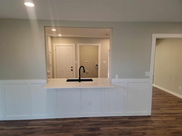 kitchen with light countertops, dark wood-style flooring, a sink, and recessed lighting