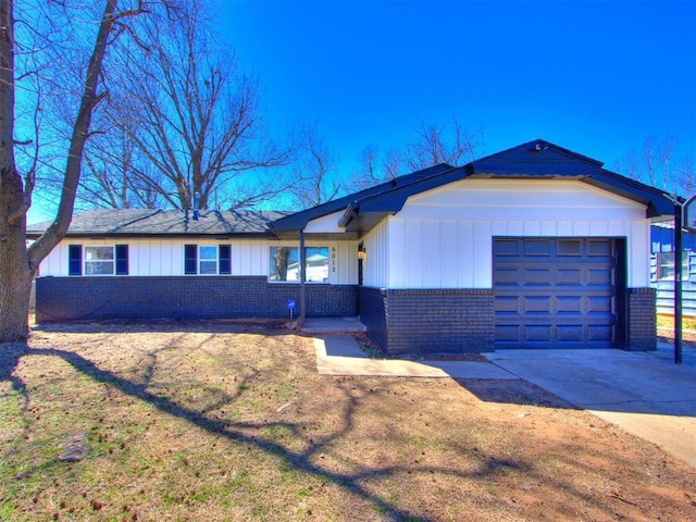 single story home with driveway, brick siding, board and batten siding, and an attached garage