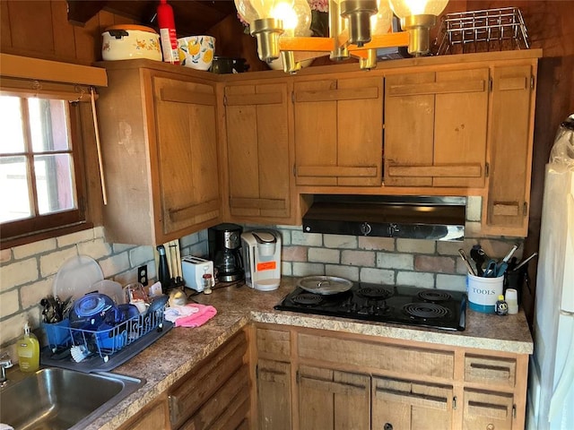 22 W Shore Dr, Arcadia, OK 73007 - kitchen featuring light countertops, backsplash, a sink, under cabinet range hood, and black electric cooktop