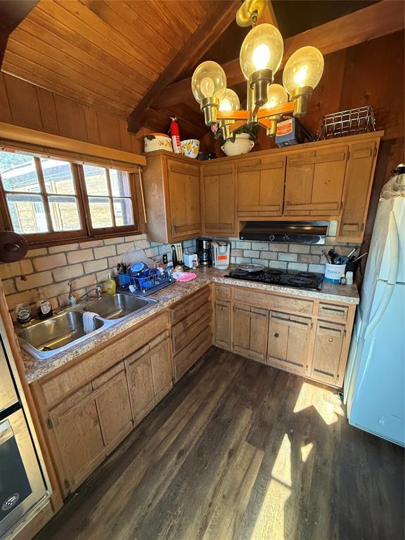 22 W Shore Dr, Arcadia, OK 73007 - kitchen featuring wooden ceiling, under cabinet range hood, dark wood-type flooring, a sink, and freestanding refrigerator