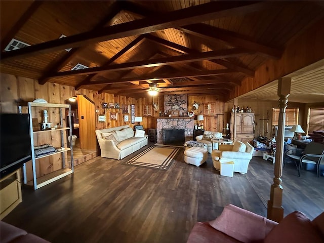 22 W Shore Dr, Arcadia, OK 73007 - living room with vaulted ceiling with beams, wood walls, wood finished floors, and a stone fireplace