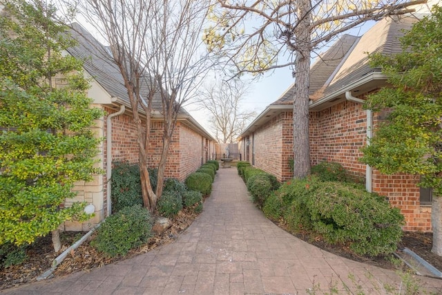 view of side of home featuring brick siding