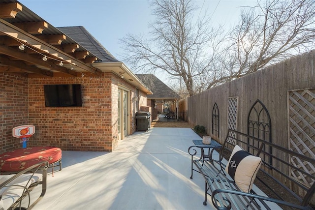 view of patio / terrace featuring fence