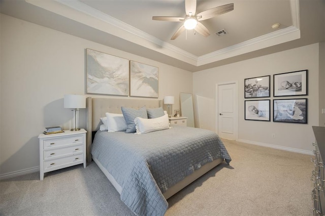 bedroom with visible vents, baseboards, a tray ceiling, crown molding, and light colored carpet