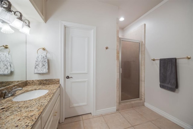 bathroom with tile patterned flooring, vanity, a stall shower, and baseboards