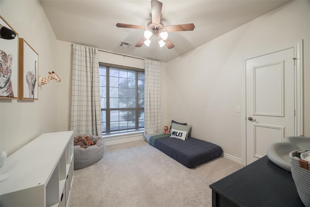 living area featuring visible vents, a ceiling fan, and carpet floors