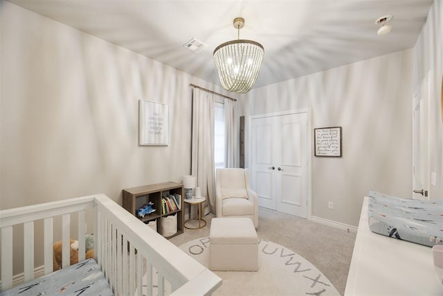 carpeted bedroom with a notable chandelier, visible vents, a nursery area, and baseboards