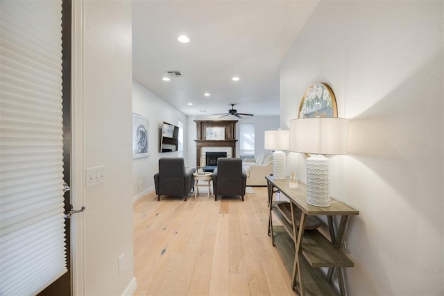 hall with recessed lighting, light wood-style floors, and visible vents