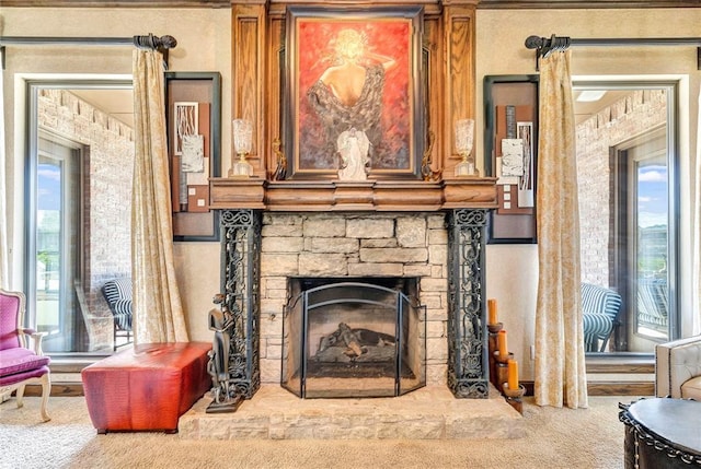 details with a stone fireplace and carpet