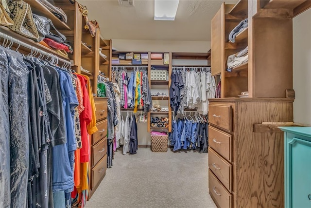 walk in closet with visible vents and carpet