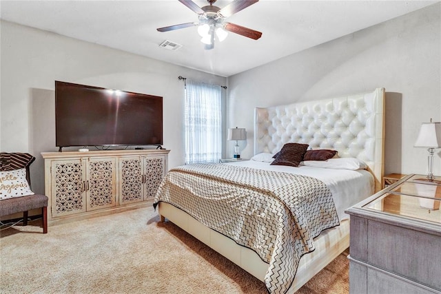 bedroom with visible vents, a ceiling fan, and carpet floors