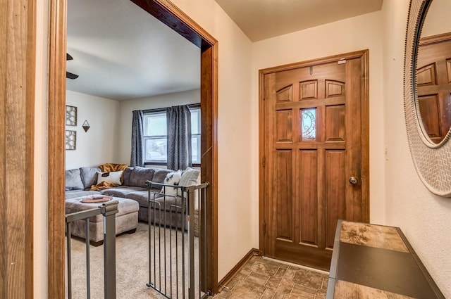 entrance foyer featuring stone finish flooring and baseboards