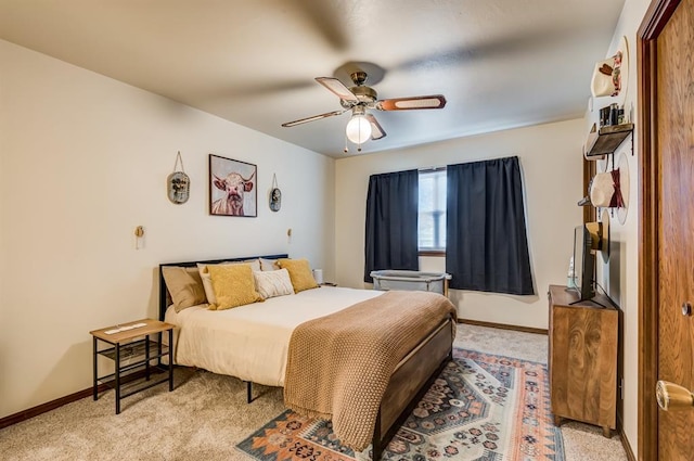 bedroom featuring light carpet, ceiling fan, and baseboards