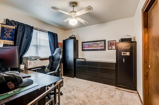 carpeted office with a ceiling fan