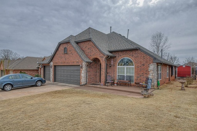 view of front facade featuring an attached garage, brick siding, driveway, roof with shingles, and a front lawn