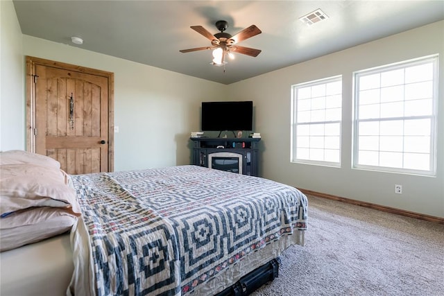 bedroom featuring ceiling fan, carpet, visible vents, and baseboards