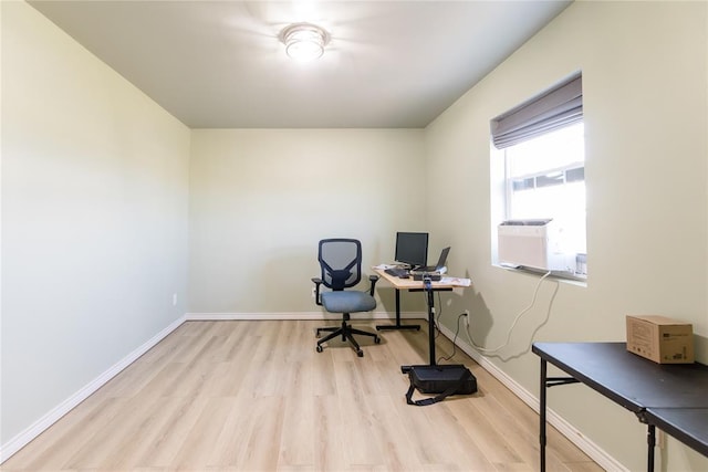 home office featuring cooling unit, light wood-style flooring, and baseboards