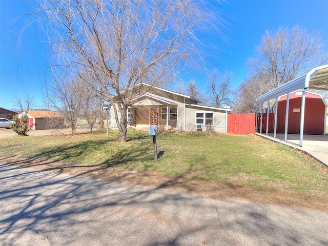 view of front of house with fence, a front lawn, and concrete driveway