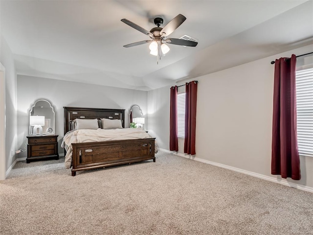 carpeted bedroom with a ceiling fan, visible vents, and baseboards