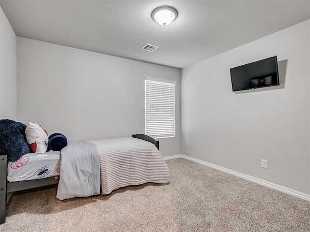 bedroom with baseboards, visible vents, and carpet flooring