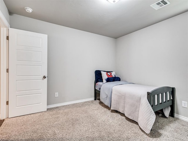 carpeted bedroom with baseboards and visible vents